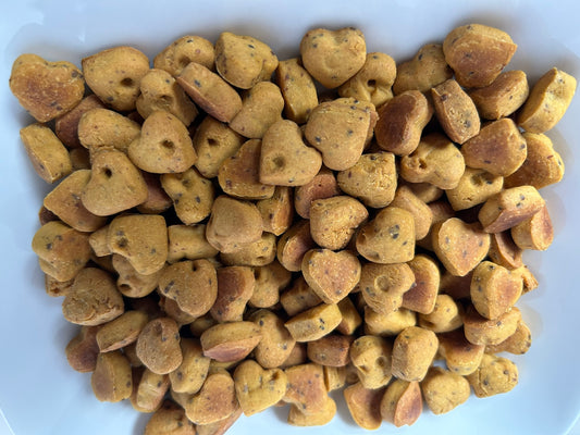 Heart-shaped dog treats on a white plate